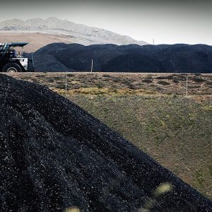 MUSWELLBROOK, AUSTRALIA - FEBRUARY 15:  A coal truck passes a huge pile of coal at BHP Billiton's Mt Arthur coal mine February 15, 2006 in Muswellbrook, Australia. BHP today posted the biggest interim profit in Australian corporate history. The world's biggest mining company announced a half-year after tax profit of $5.9 billion AUD ($4.37 billion USD) a rise of almost 48 per cent from last year.  (Photo by Ian Waldie/Getty Images)